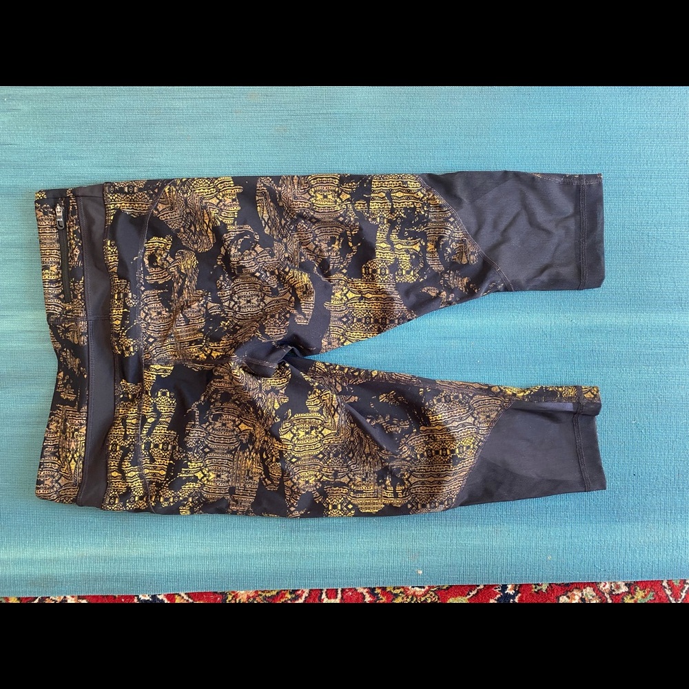 Lole three quarter leggings with gold, black and mesh details.